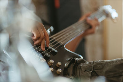 Close up musician playing bass guitar
