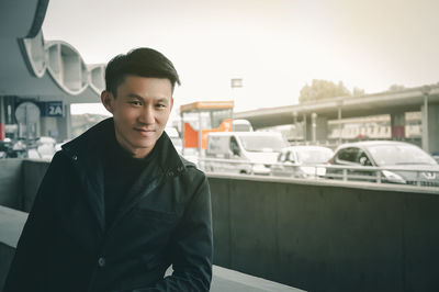 Portrait of mature man sitting in city