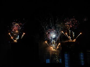 Low angle view of firework display at night