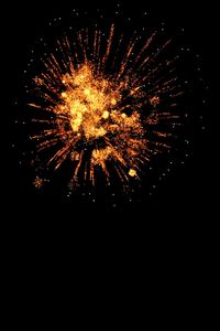 Low angle view of firework display at night