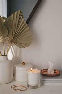 Modern trendy interior details. burning candle, home decor, feminine accessories