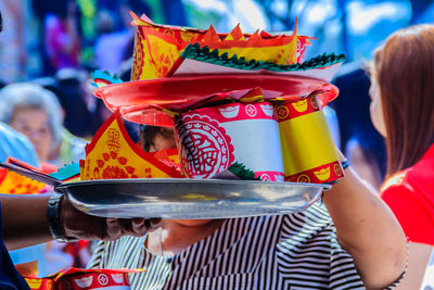 Close-up of woman holding multi colored umbrella