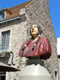 Low angle view of man standing against building