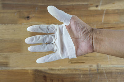 Midsection of man holding umbrella on hardwood floor