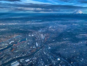 High angle view of city by sea against sky tacoma and rainier