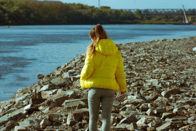 Rear view of woman standing on beach