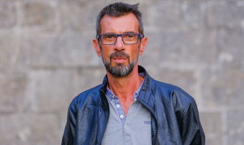 Portrait of man wearing eyeglasses standing outdoors