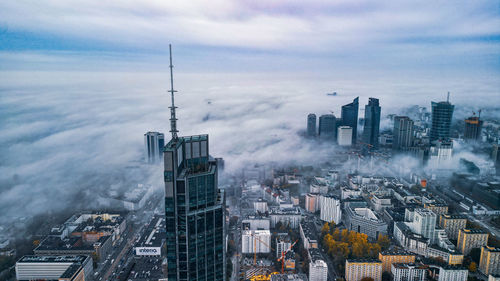 Cityscape against cloudy sky