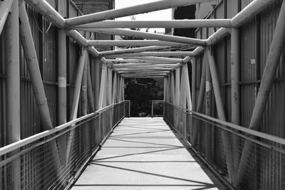 Narrow footbridge along railings