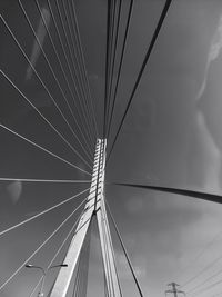 Low angle view of suspension bridge against sky