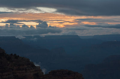 Scenic view of mountains against cloudy sky