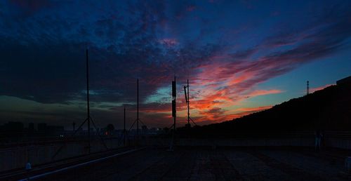 Silhouette of road against dramatic sky