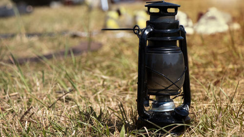 Close-up of electric lamp on field