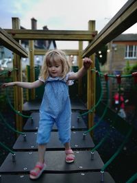 Full length of girl walking on footbridge in playground