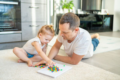 Boy playing with toy blocks at home