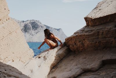 Woman sitting on rock