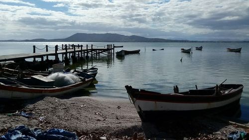 Boats moored in sea against sky