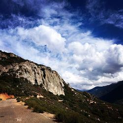 Scenic view of mountains against cloudy sky