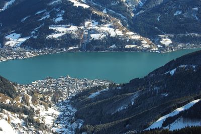 Aerial view of alpine zell am see city and lake in sunny winter austria