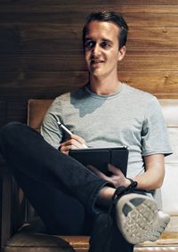 Young man using mobile phone at home