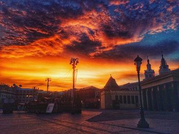 Silhouette of built structure against cloudy sky at sunset
