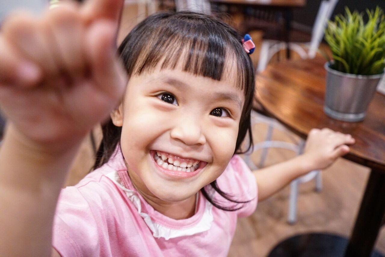 CLOSE-UP PORTRAIT OF CUTE SMILING GIRL