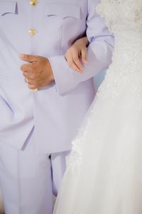 Close-up of hand holding white dress