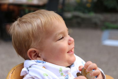 Portrait of cute baby girl looking away outdoors