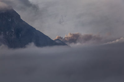 Scenic view of mountains against cloudy sky