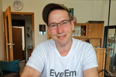 Portrait of man wearing eyeglasses at home