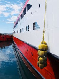 Boat moored at harbor against sky