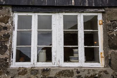 Low angle view of window in abandoned building