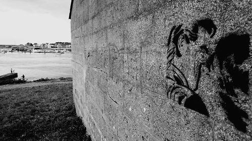 Tilt image of wall against sky in city