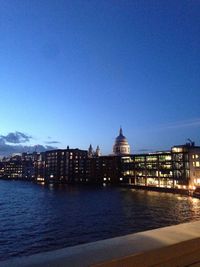 Illuminated cityscape against clear sky at dusk