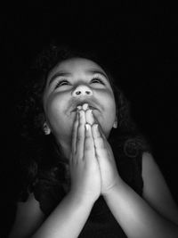 Portrait of baby boy against black background