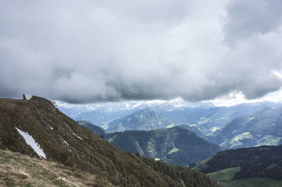 Scenic view of mountains against cloudy sky