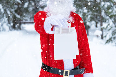 Midsection of woman holding snow