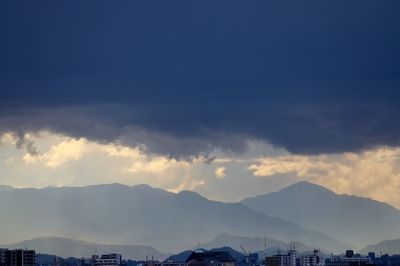 Cityscape against cloudy sky