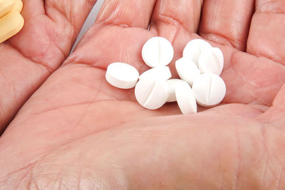 Close-up of hands holding pills