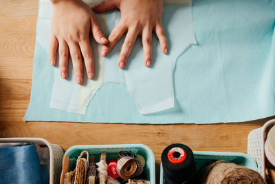 High angle view of hands on table