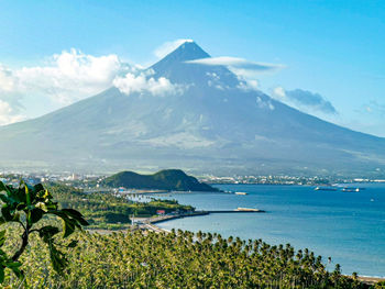 Scenic view of sea and mountains against sky