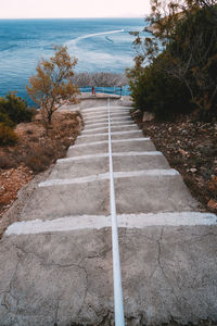 High angle view of footpath by sea against sky