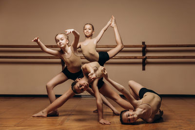 Black and white image of a group of modern little ballerinas standing in a modern dance pose. 