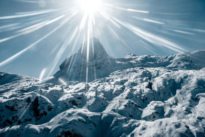 Scenic view of snow covered mountains against sky