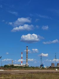 Factory on field against sky