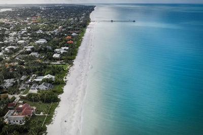 High angle view of sea and buildings in city