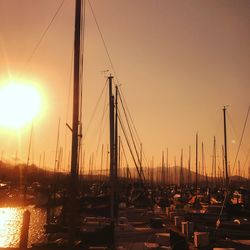 Sailboats in sea at sunset