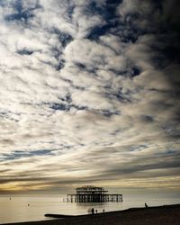 Low angle view of beach against sky during sunset