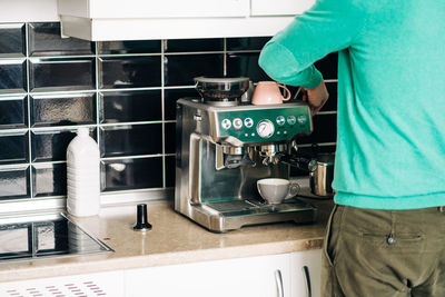 Man standing in kitchen at home