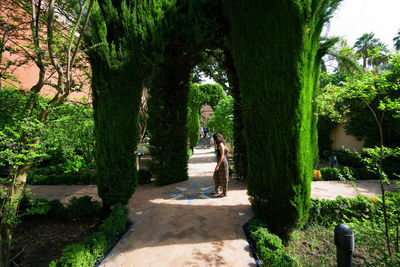 Woman walking on footpath in park